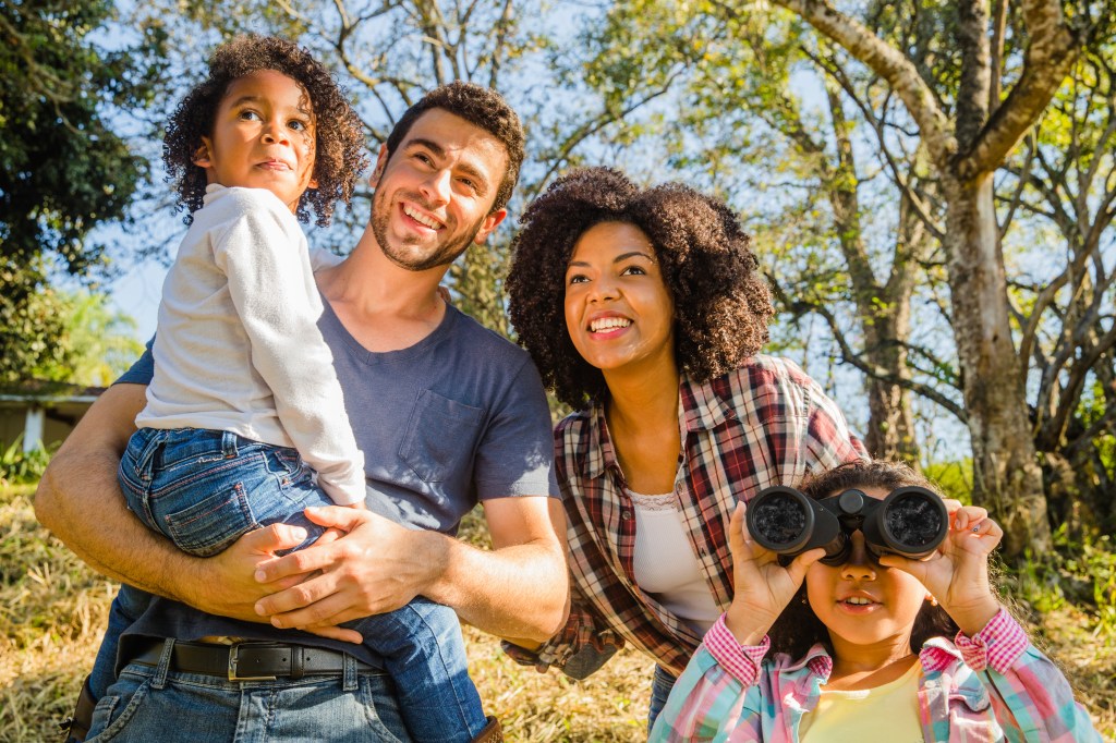 Image of a family looking off into the distance in the woods.